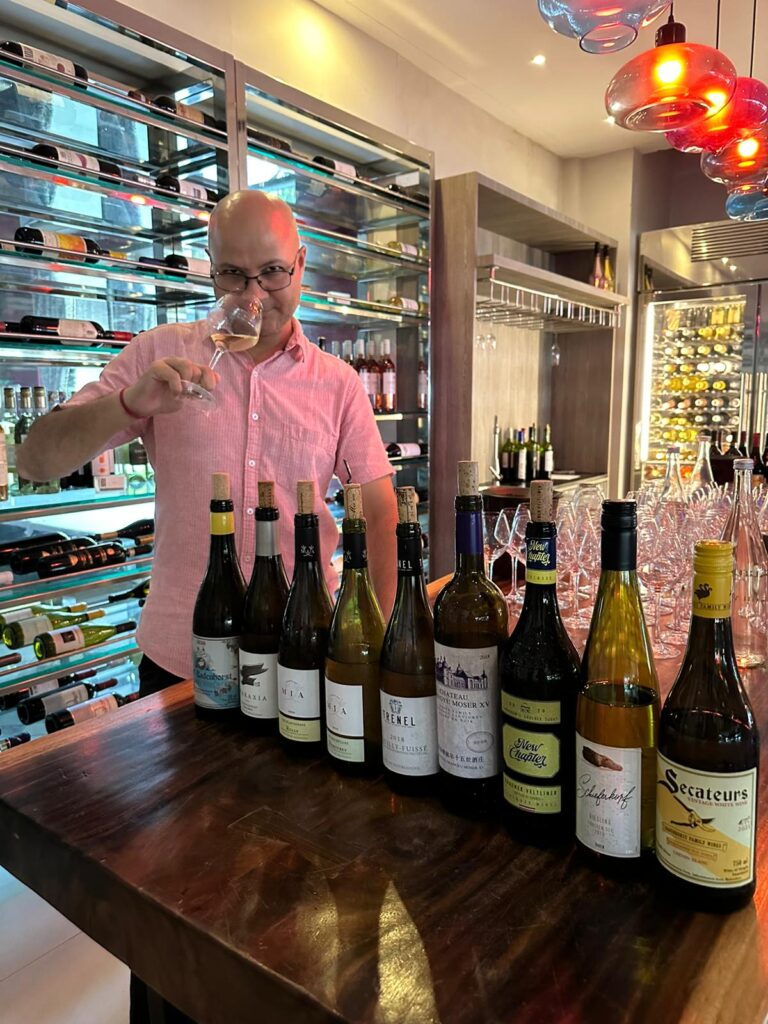 Kamal Malik, MS sampling wines at a cellar.