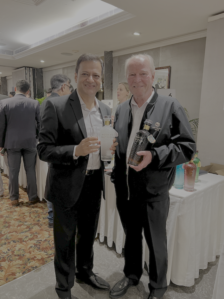 Author with distillery representative holding Mermaid salt vodka and spiced rum